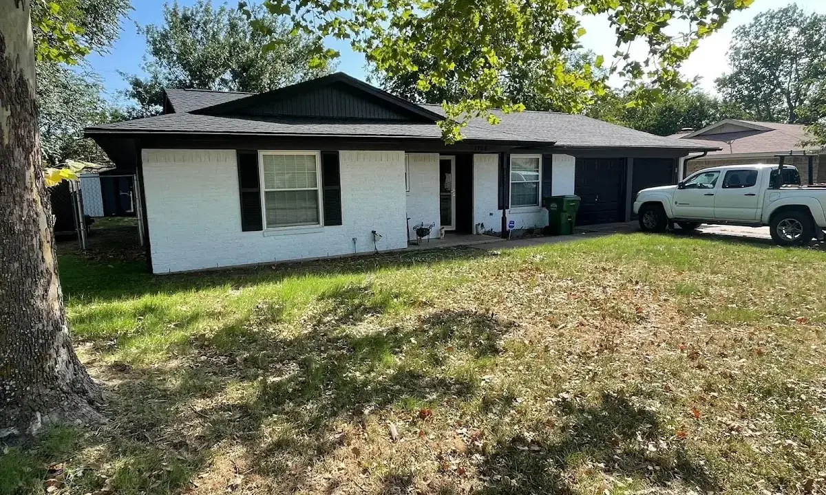 Professional roofing crew working on a residential roof in Lindstrom